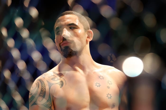 Robert Whittaker (blue gloves) before the fight against Israel Adesanya (red gloves) during UFC 271 at Toyota Center.